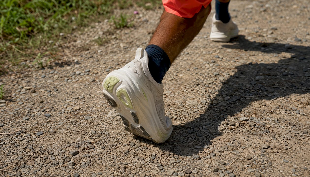 Hoka Clifton 10: Built for Long Daily Miles 2026 Lizard's Lunch Close-up of foot striking pavement in Hoka Clifton 10