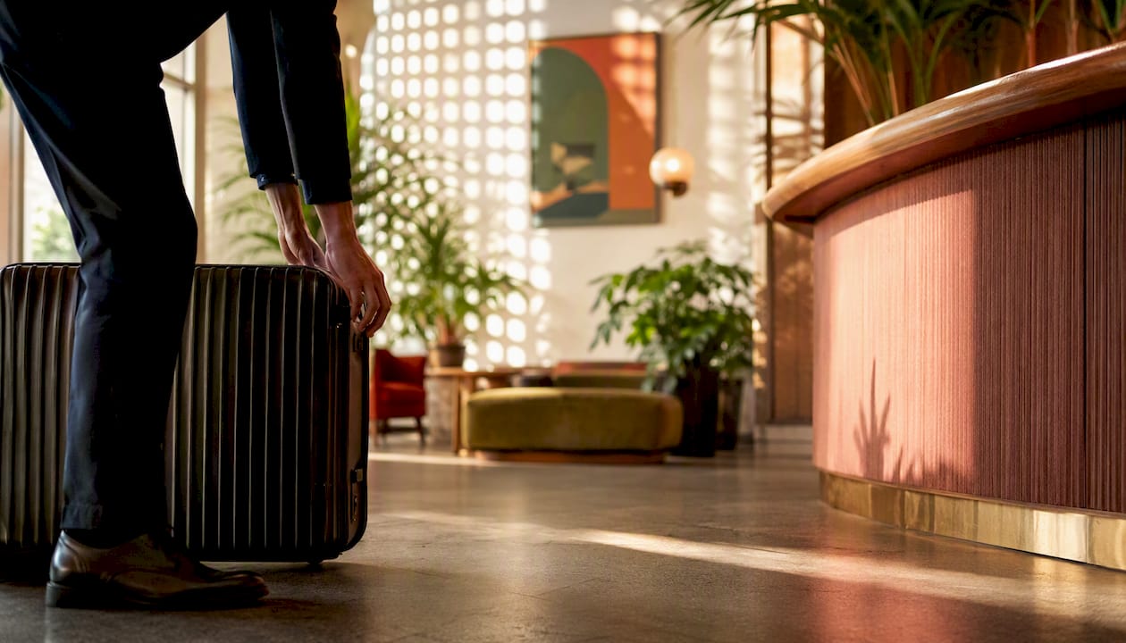 30+ Proven Ways to Save on Travel for Canadians 2026 Lizard's Lunch Hotel lobby with luggage near check-in desk