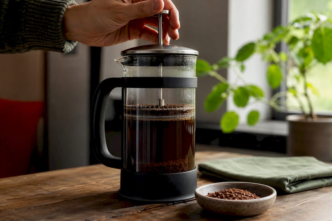 10 Coffee Maker Types for Every Home Routine and Care Tips 2026 Lizard's Lunch Hand pressing a French press plunger